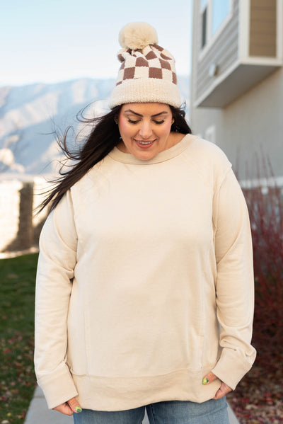 Front view of a plus size taupe sweater