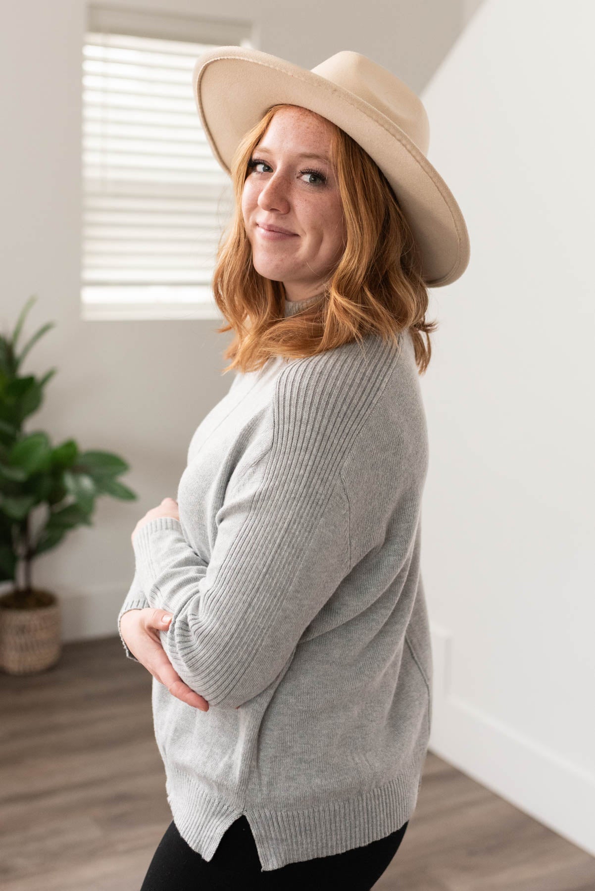 Side view of the heather grey sweater