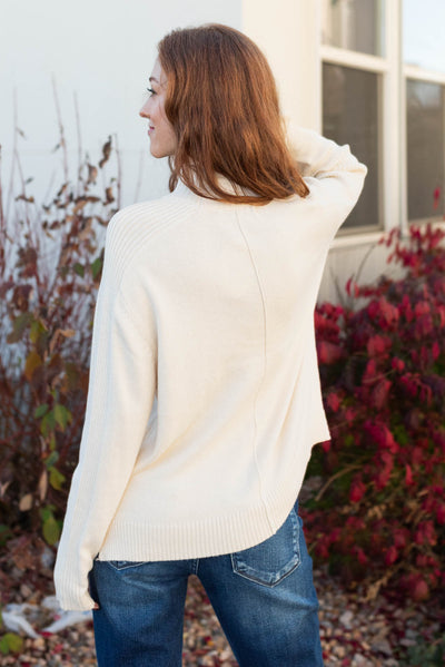 Back view of a ivory sweater