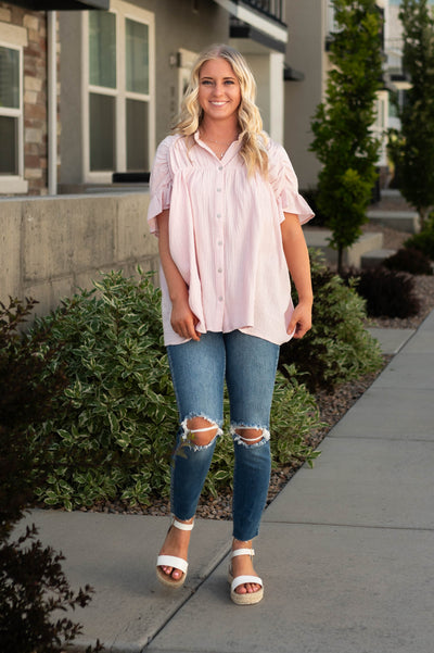 Blush top that buttons up and has a collar