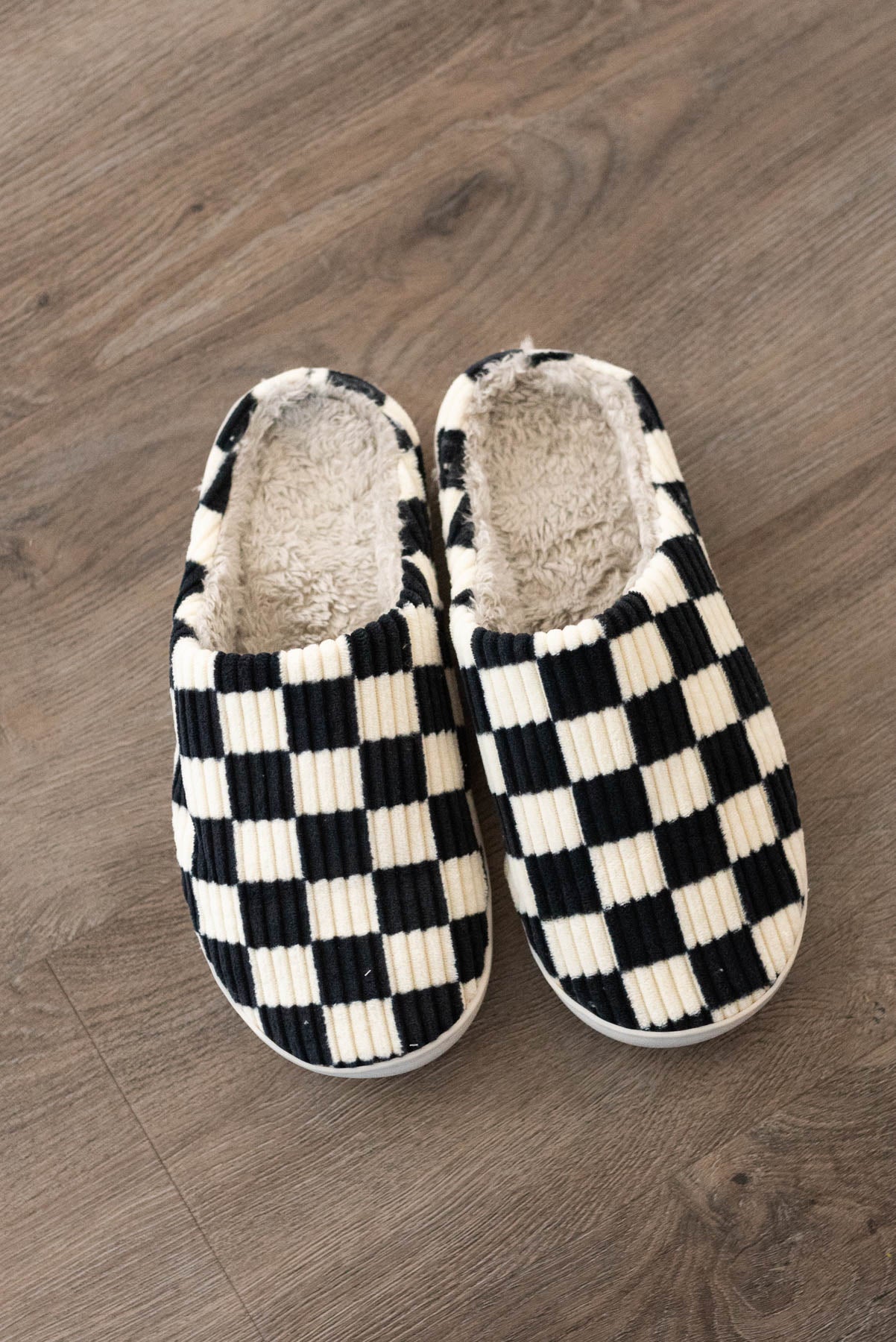 Front view of a black checkered slippers
