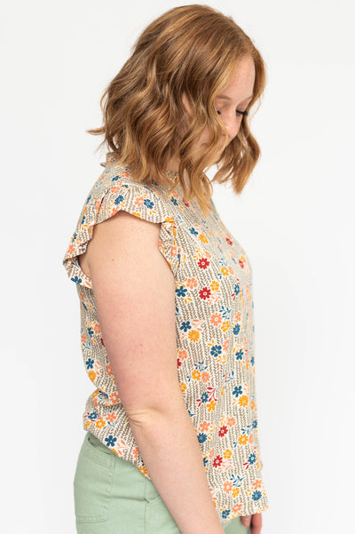 Side view of a taupe floral top