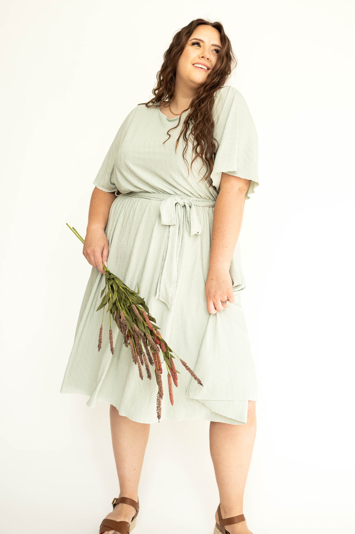 Plus size sage colored dress that ties at the waist