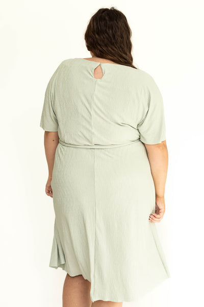 Back view of a plus size sage colored dress