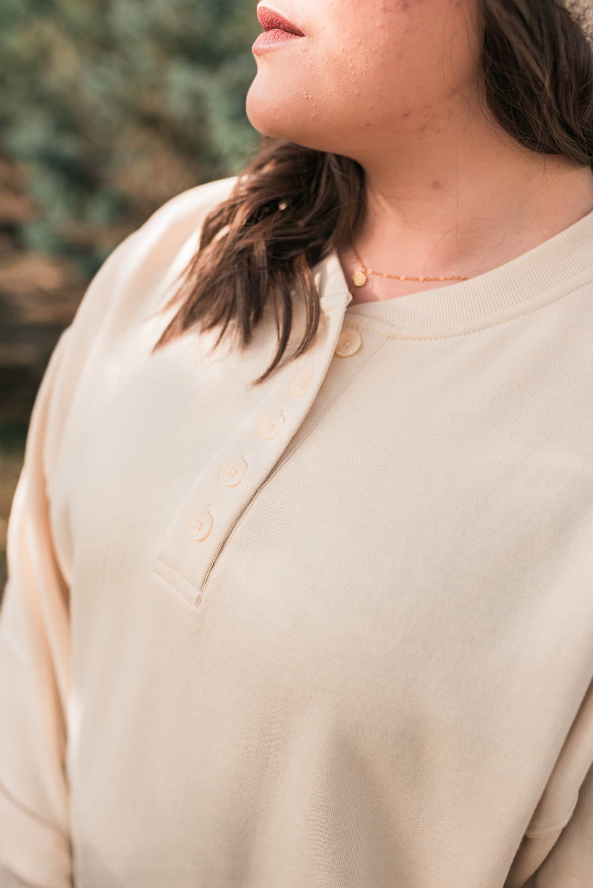 Buttons on a plus size cream fleece sweatshirt