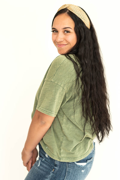 Side view of a bright sage top.