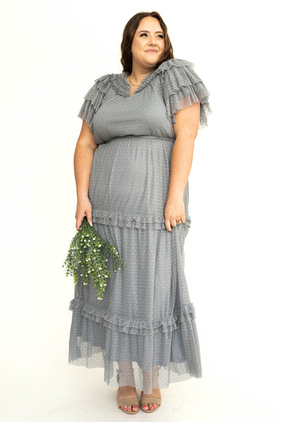 Front view of a plus size blue gray lace short sleeve dress with ruffles on sleeves and neck.