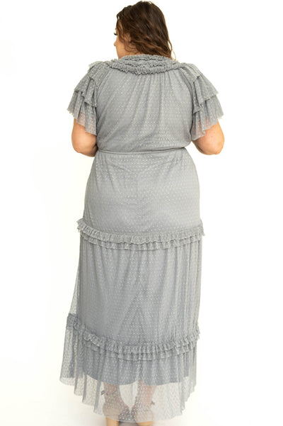 Back view of a plus size blue gray lace short sleeve dress with ruffles on sleeves and neck.