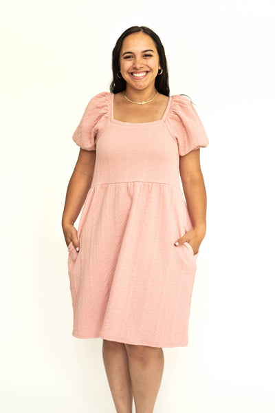Front view of a dusty pink short sleeve knee length square neck dress.