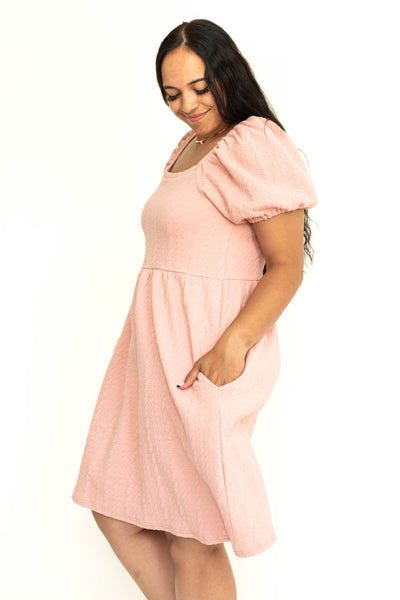 Side view of a dusty pink short sleeve knee length square neck dress.