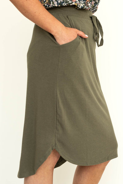Side view of a draw string knit olive skirt.