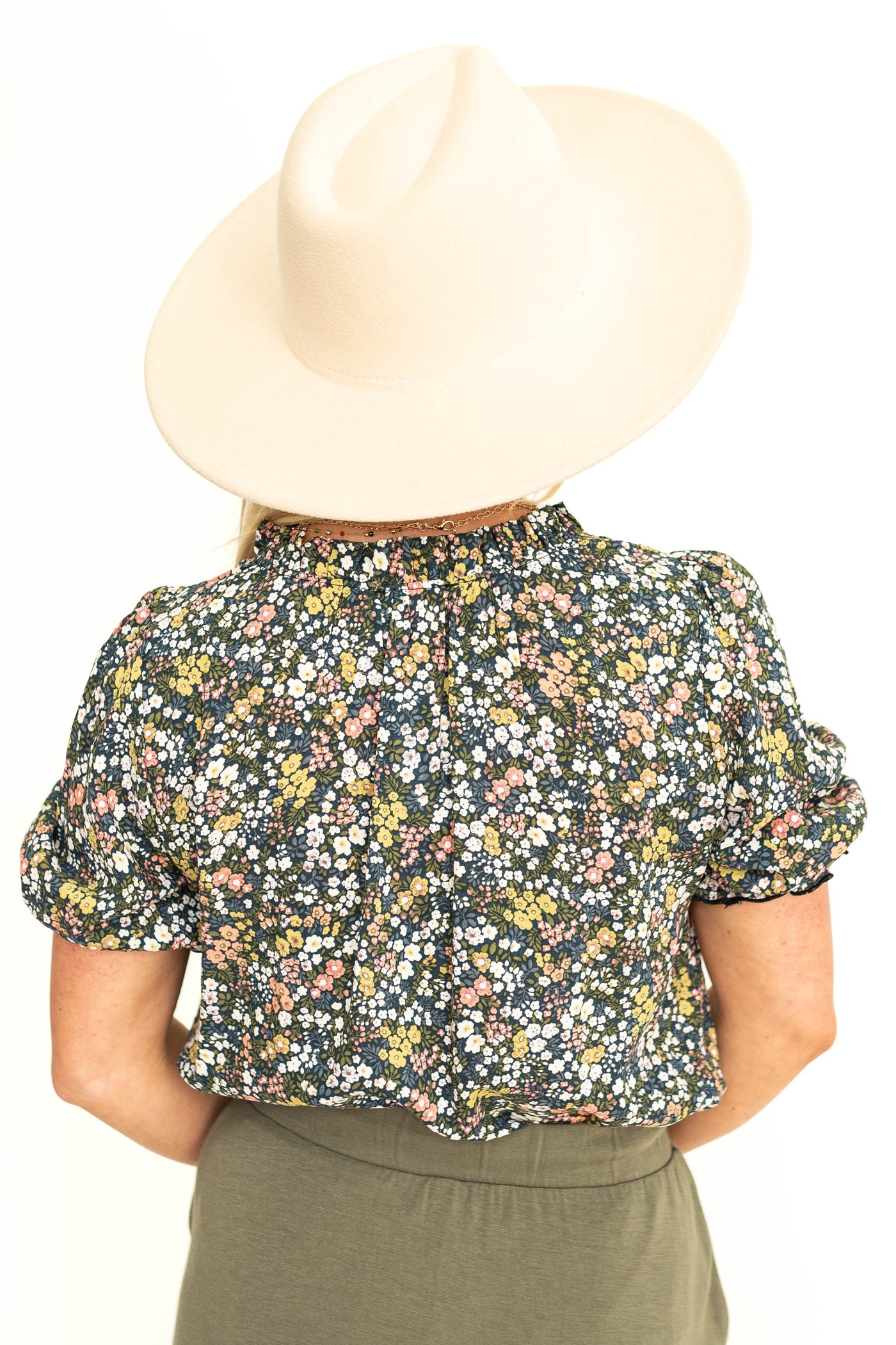 Back view of a short sleeve navy floral print.