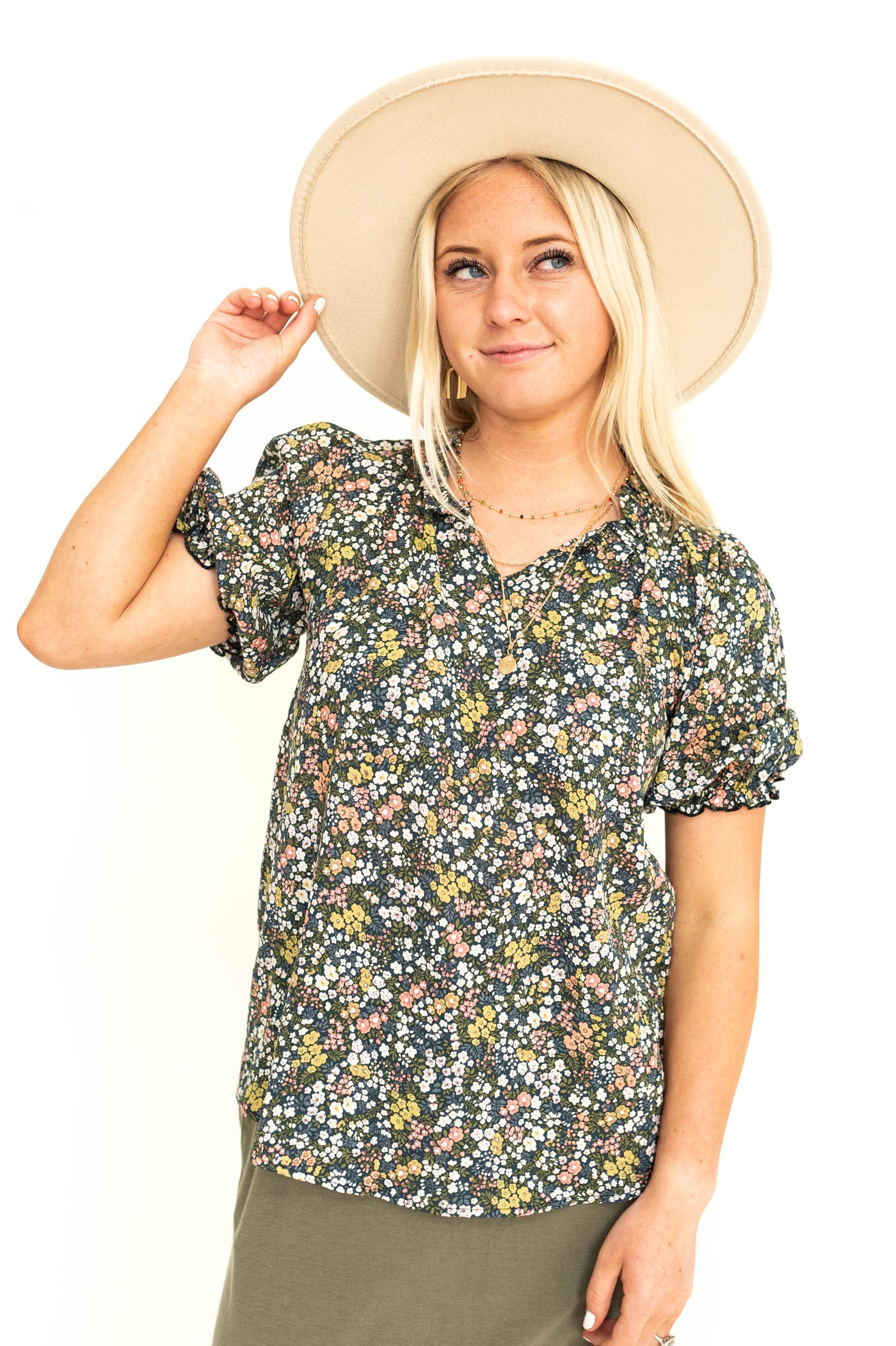 Front view of a short sleeve navy floral top.
