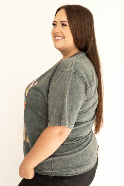 Side view of a back view of a blue gray cowboy graphic t-shirt .