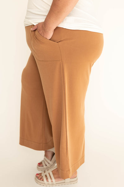  Side view of a mocha wide leg knit pants.