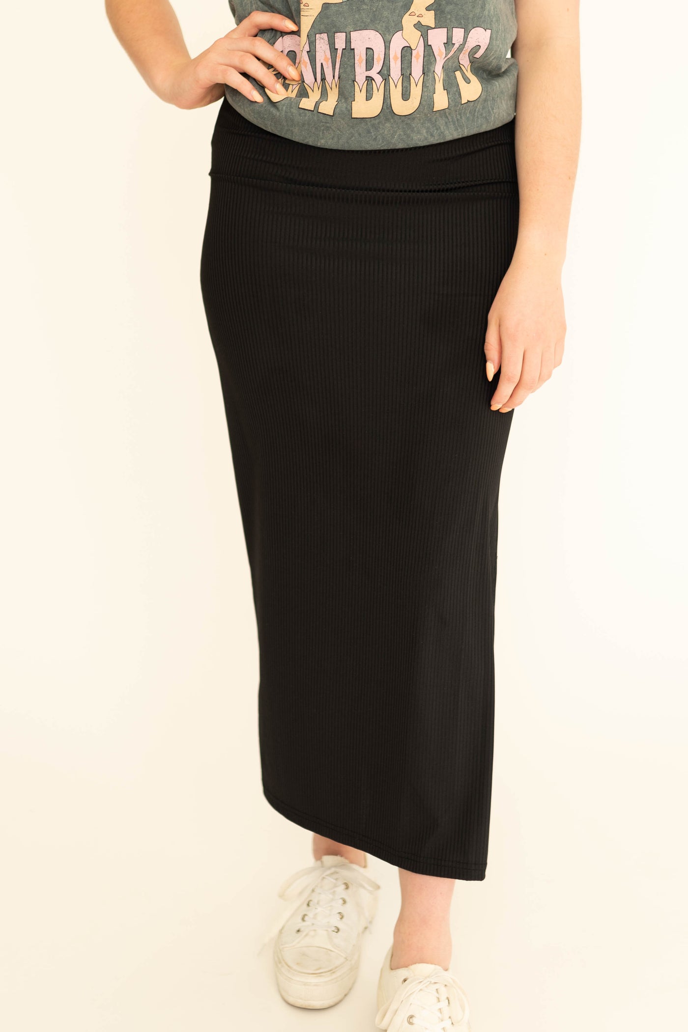 Front view of a black fitted skirt with side slit.  Come in small to 3x.