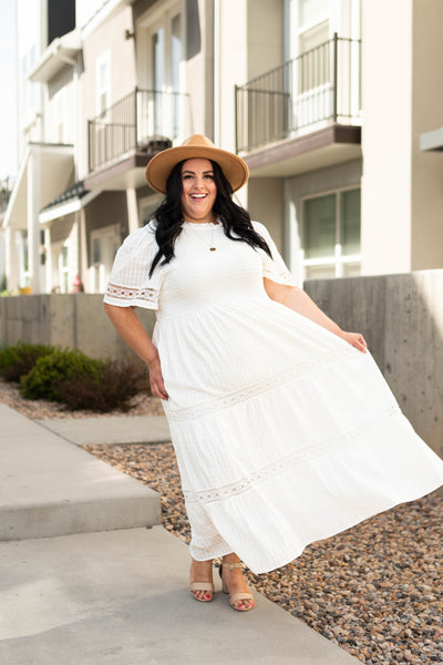 Curvy white tiered dress with lace detail.