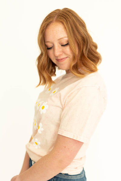 Side view of a peach daisy t-shirt