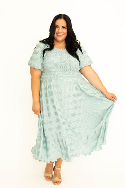 Front view of a plus size seafoam dress with smocked bodice.  