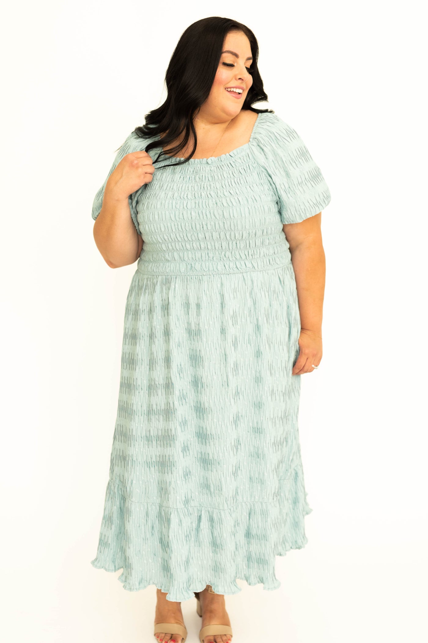 Front view of a plus size short sleeve seafoam dress with smocked bodice.