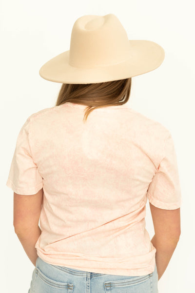 Back of a stone pink daisy graphic tee
