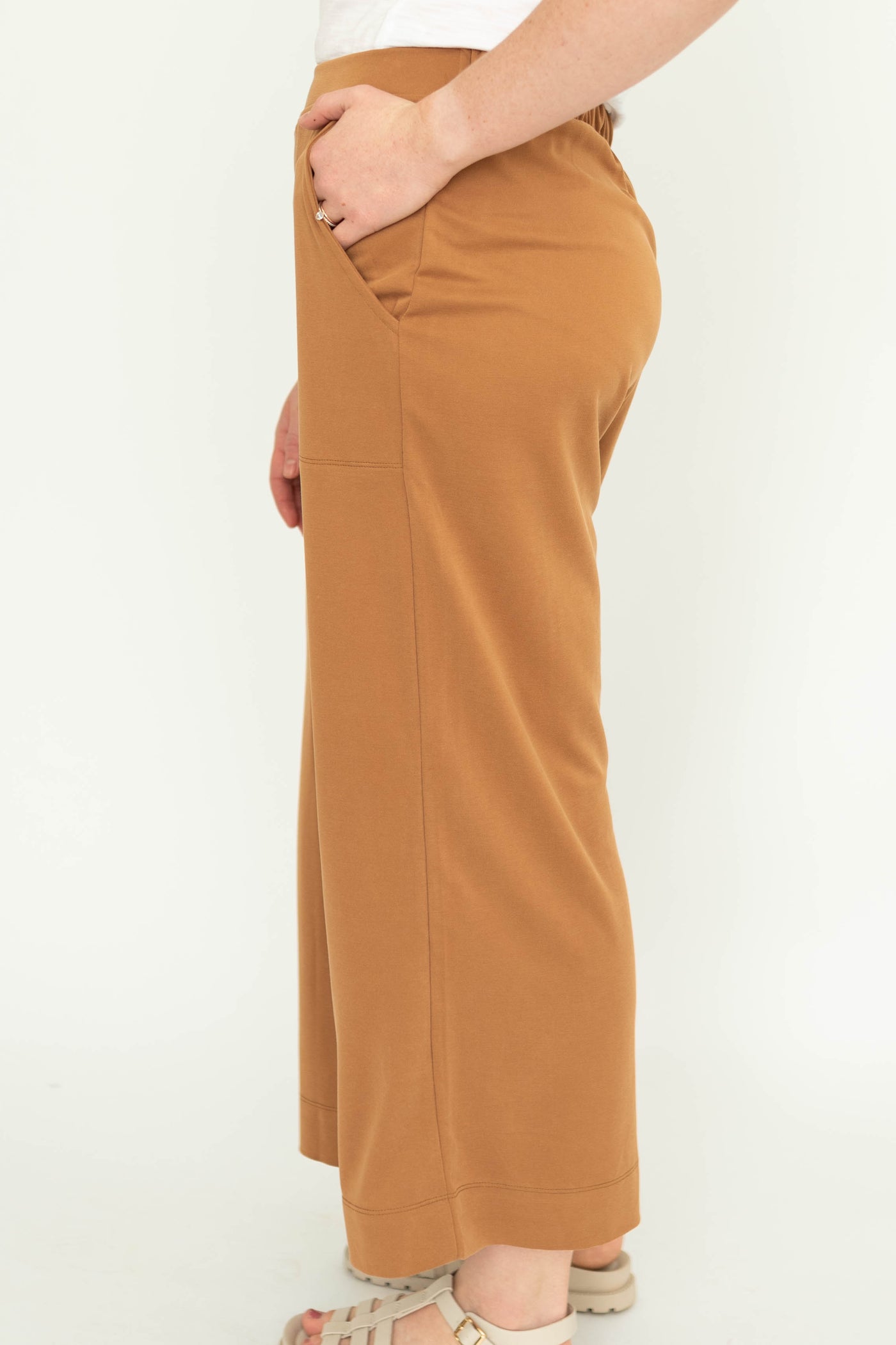 Side view of a mocha colored wide leg knit pants.