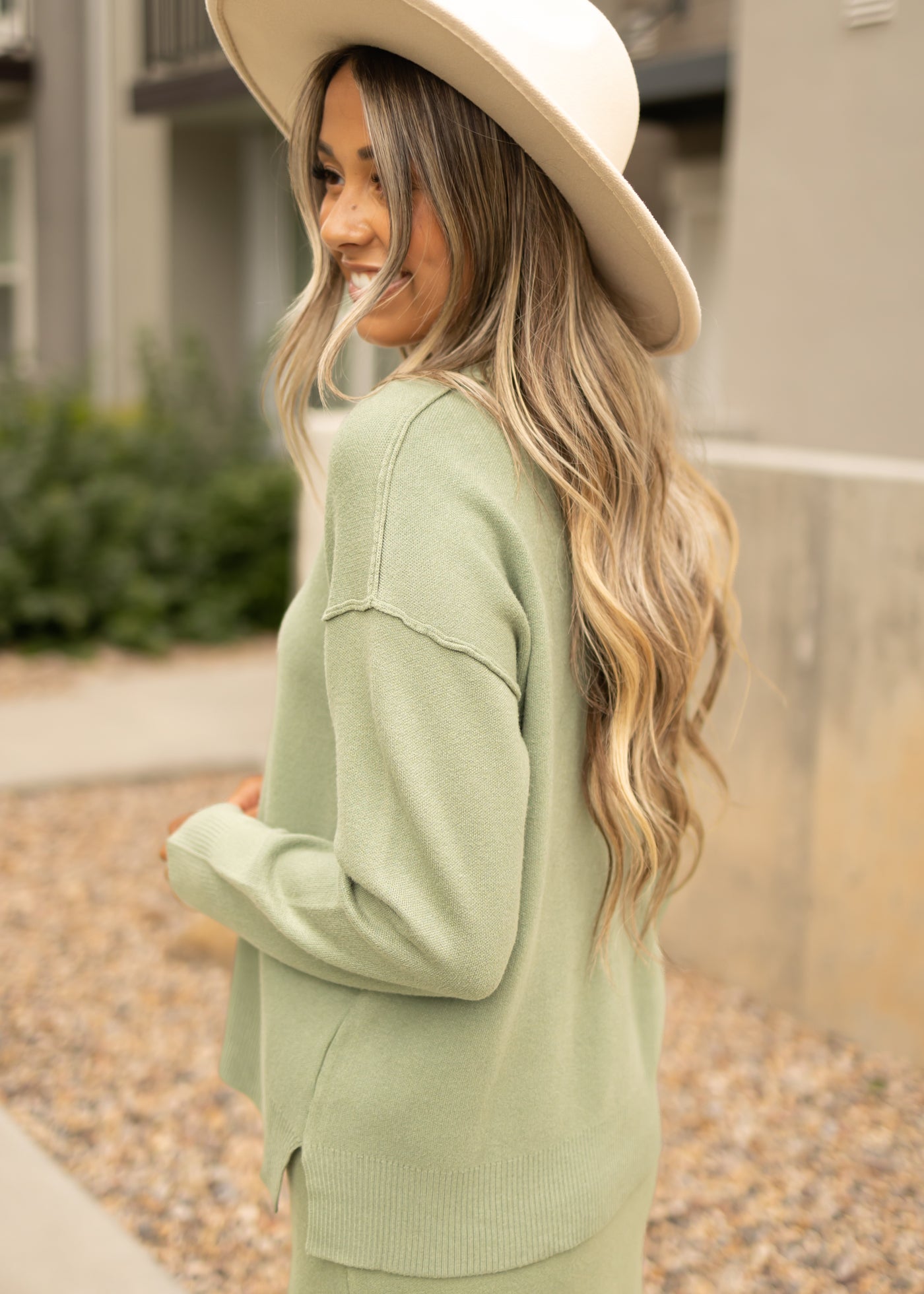 Side view of a toasted sage sweater