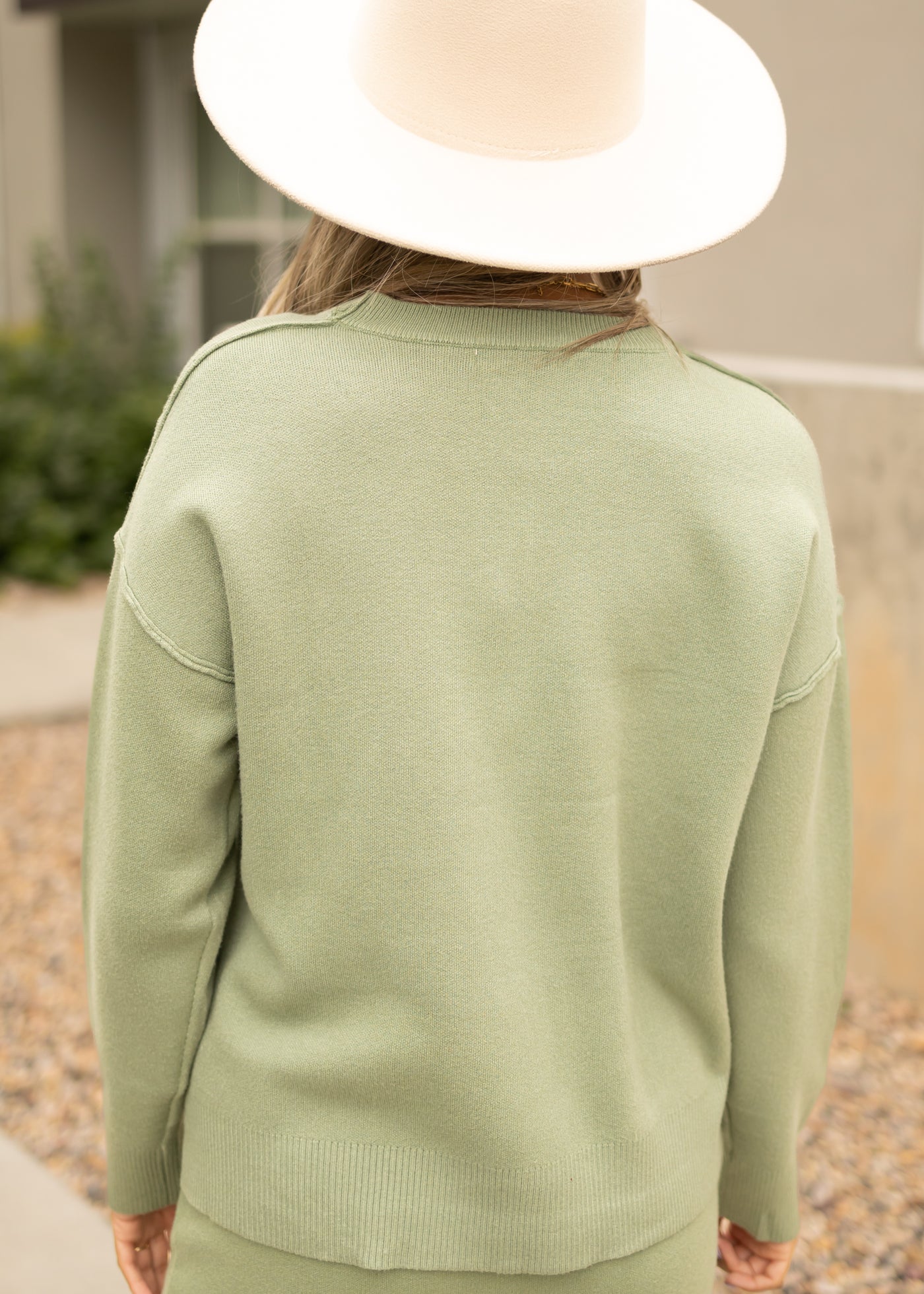 Back view of a toasted sage sweater