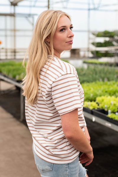 Side view of the white taupe striped top