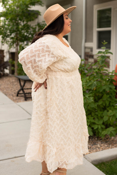 Side view of a cream textured dress
