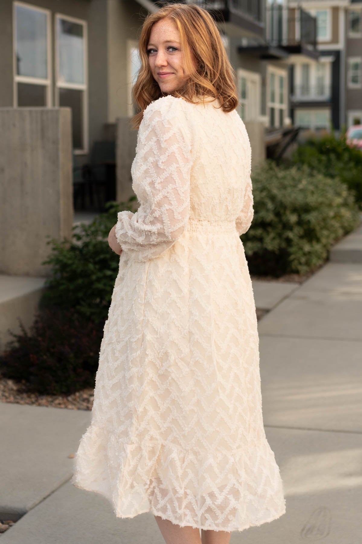 Side view of a cream textured dress