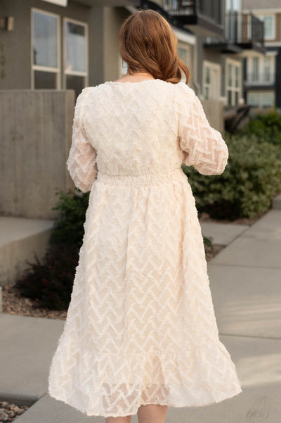 Back view of a cream textured dress
