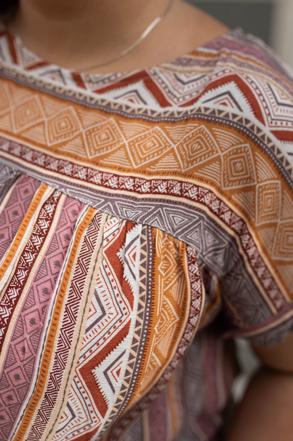 Close up of a plus size multi top