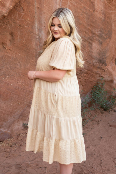 Side view of a plus size beige dress