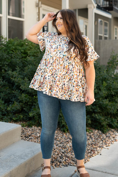 Plus size cream top with short sleeves and flower print