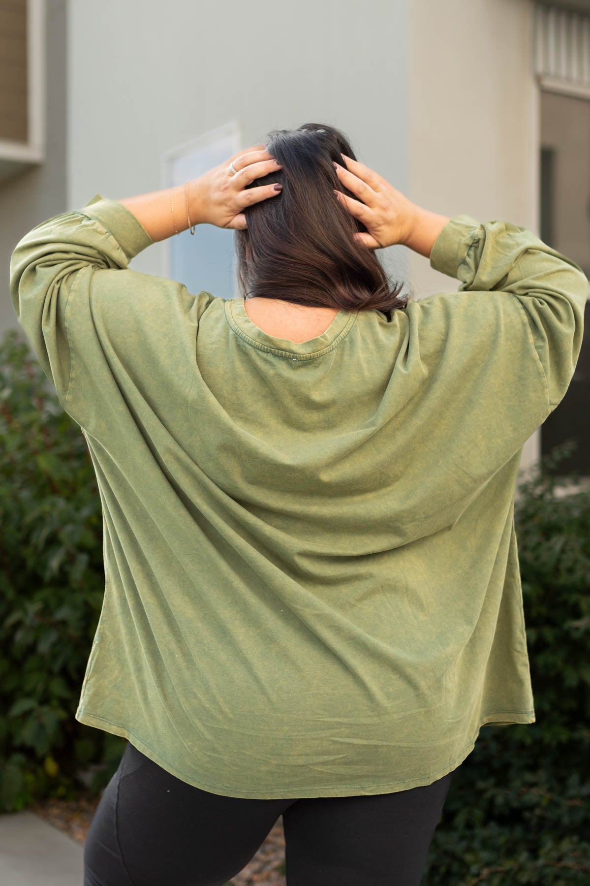 Back view of a plus size olive pullover
