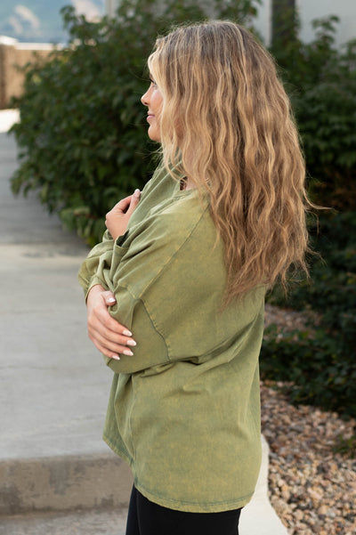 Side view of a olive pullover