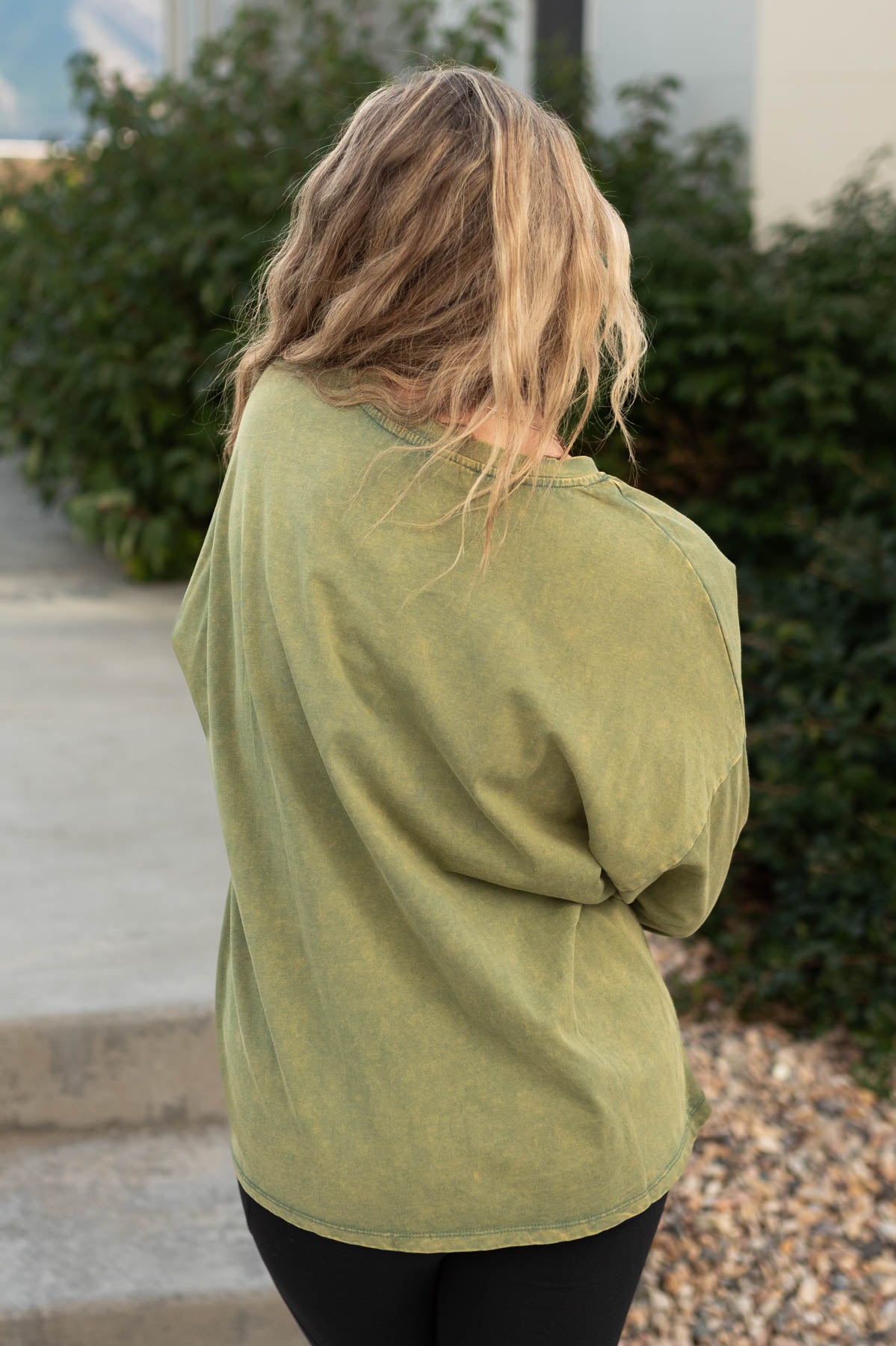 Back view of a olive pullover
