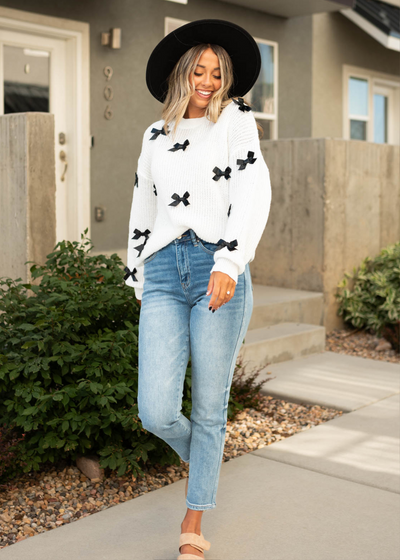 White sweater with black bows