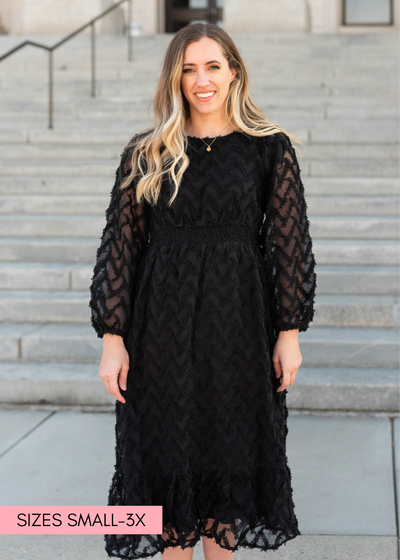 Textured fabric on a black dress with long sleeves