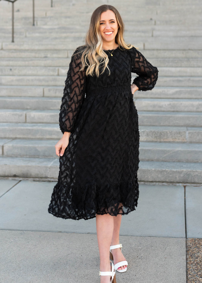 Black dress with long sleeves and textured fabric