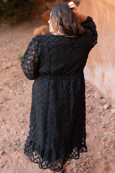 Back view of a plus size black dress