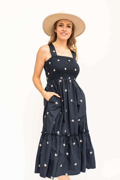 Navy sundress, smocked bodice with floral print.