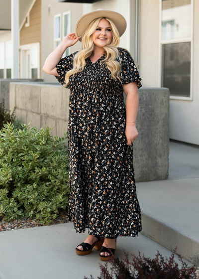 Plus size black floral dress with smocked top
