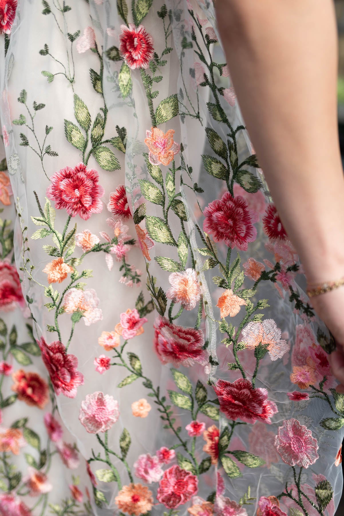 Close up of the floral embroidery on the pink embroidered mesh dress