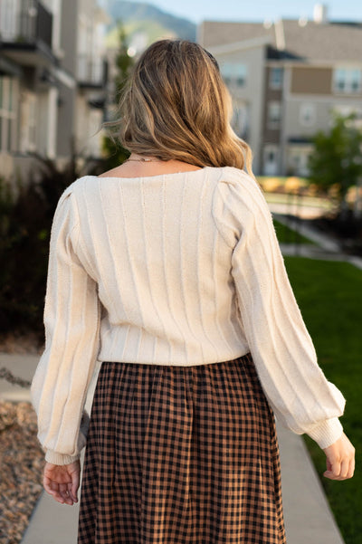 Back view of a taupe sweater