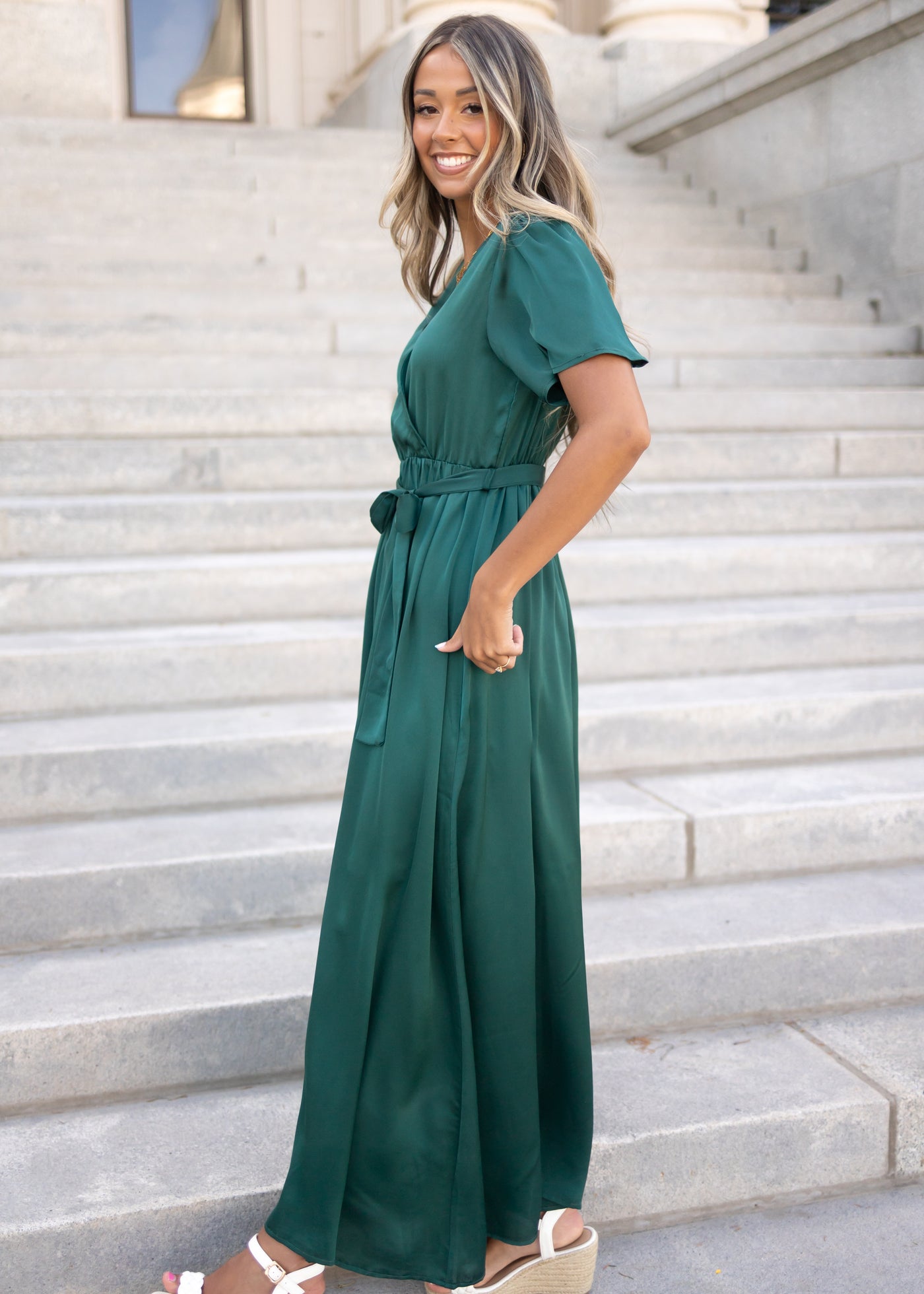Side view of a hunter green dress with short sleeves