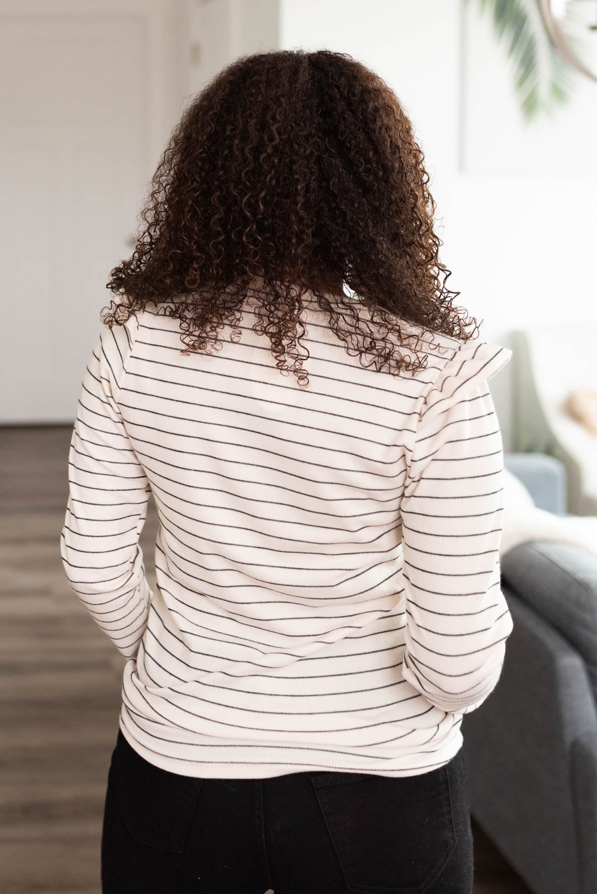 Back view of a ivory stripe ruffle top