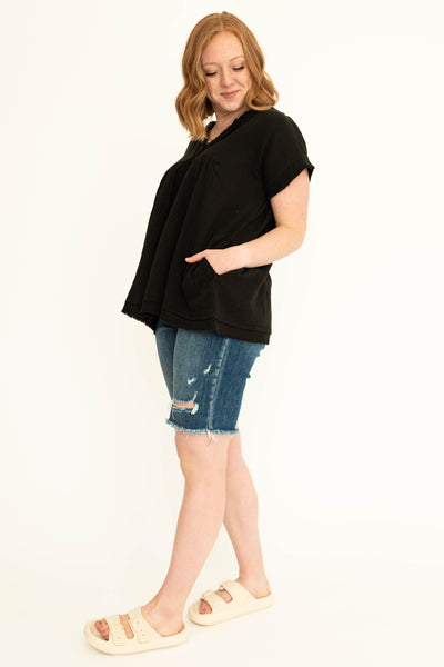 Side view of a black top with pockets