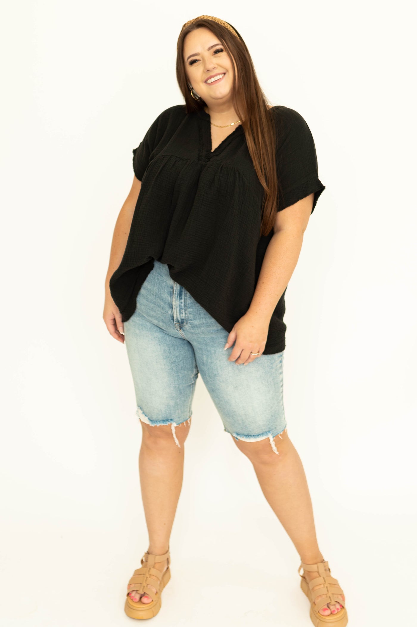 Front view of a plus size black top with pocket